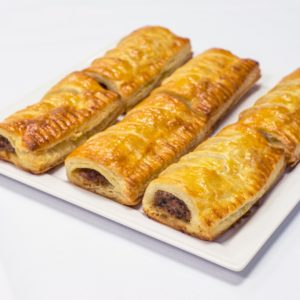 sausage rolls on a plate made using puff pastry