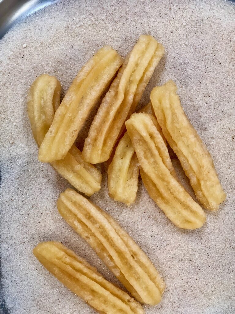 Homemade churros rolled in cinnamon sugar